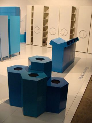 Blue Geometric designed Bins on display, along side white shelves