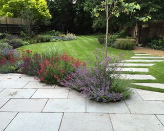stone patio and pathway leading across a lawn
