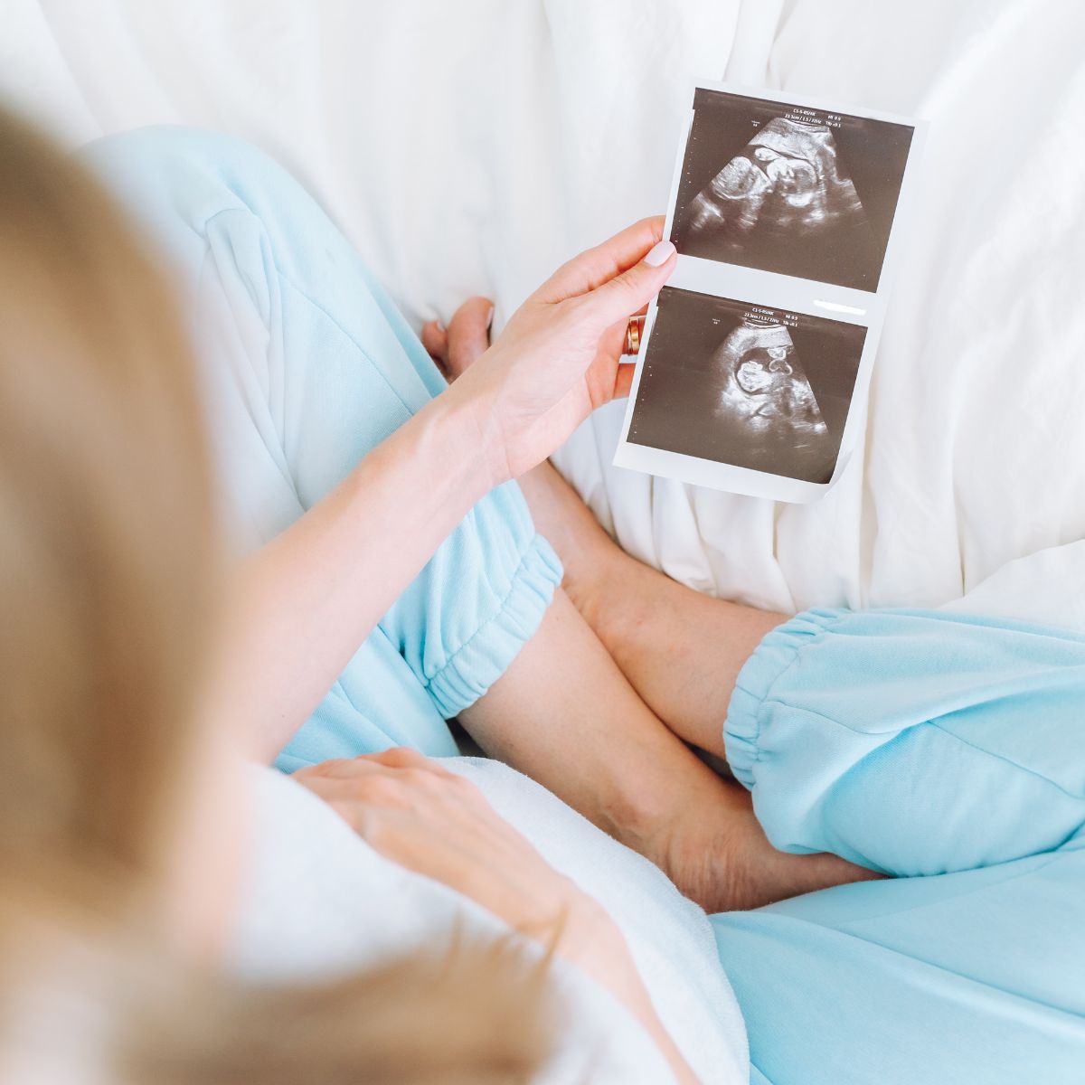 Woman holding baby scan via IVF