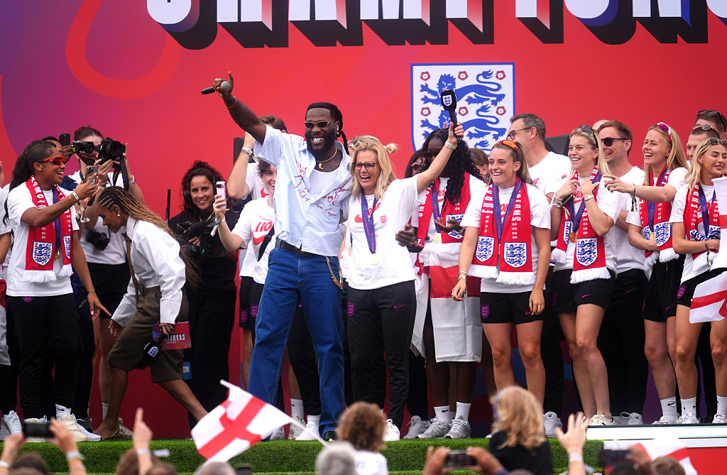 Burna Boy performs as England manager Sarina Wiegman and players celebrate on stage during a Homecoming Victory Parade on the Mall, on July 29, 2025 in London, England. England defeated Spain in the UEFA Women's EURO 2025 Final to retain the trophy on 27 July.