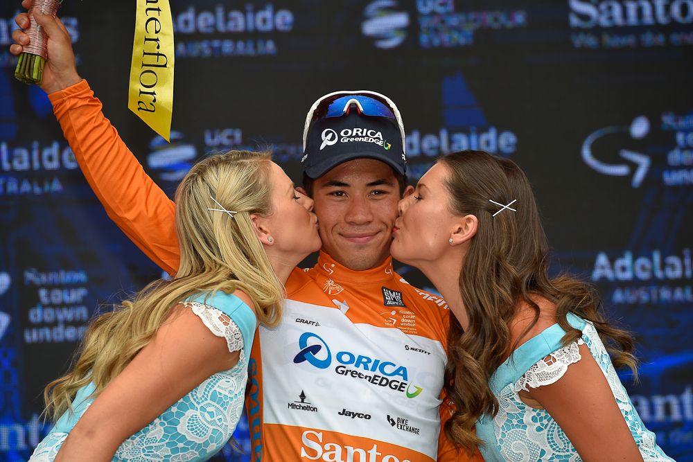 Caleb Ewan wears the ochre jersey on the stage 1 podium.