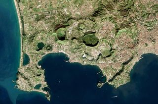 A 2016 satellite image showing the breathing landscape of Campi Flegrei pockmarked by craters.