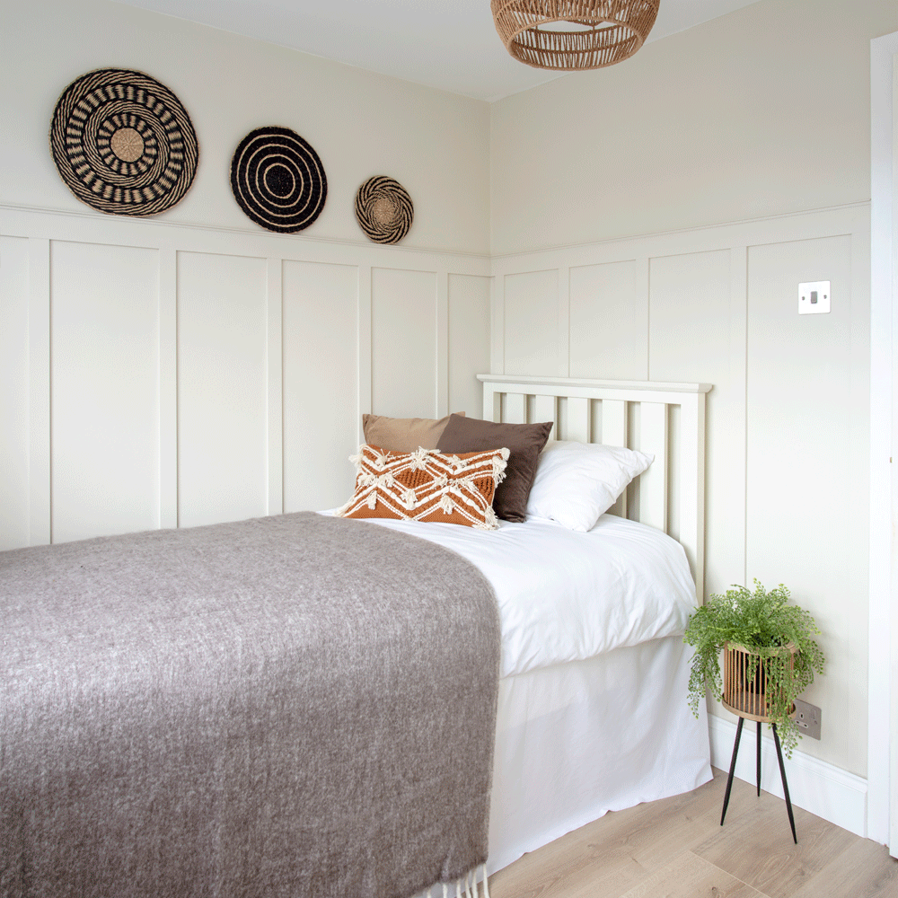 guest bedroom with panel pins and wooden flooring