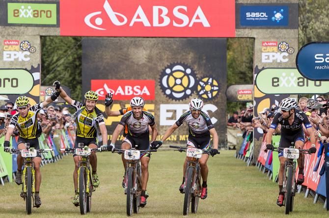 Overall Yellow Jersey holders Robert Mennen (far left) and Kristian Hynek (centre left) of Topeak-Ergon Racing celebrate as the cross the line to win the Cape Epic as Frantisek Rabon (centre right) and Christoph Sauser (far right) of Meerendal Songo Specialized finish second overall