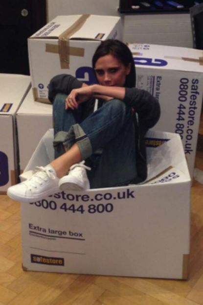 Victoria Beckham gets stuck in while packing clothes for charity