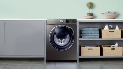 A Samsung 9kg Quick Drive Washing Machine in a laundry room