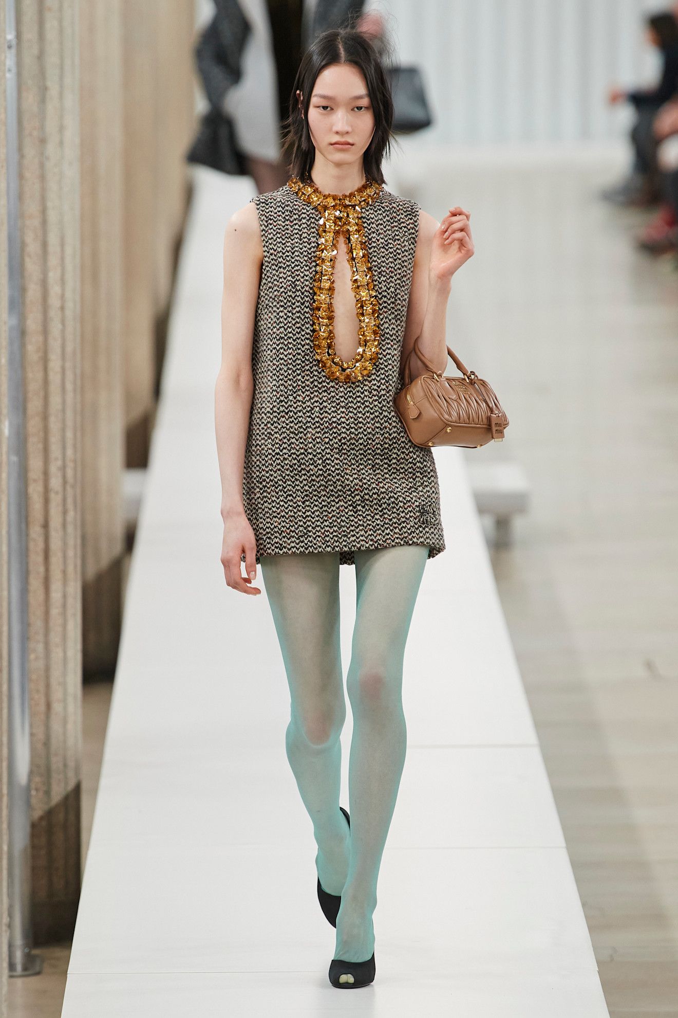An image of light blue tights on the Miu Miu autumn/winter 2023 runway.