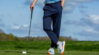 A golfer poses in the Manors Golf The Lightweight Course Pant