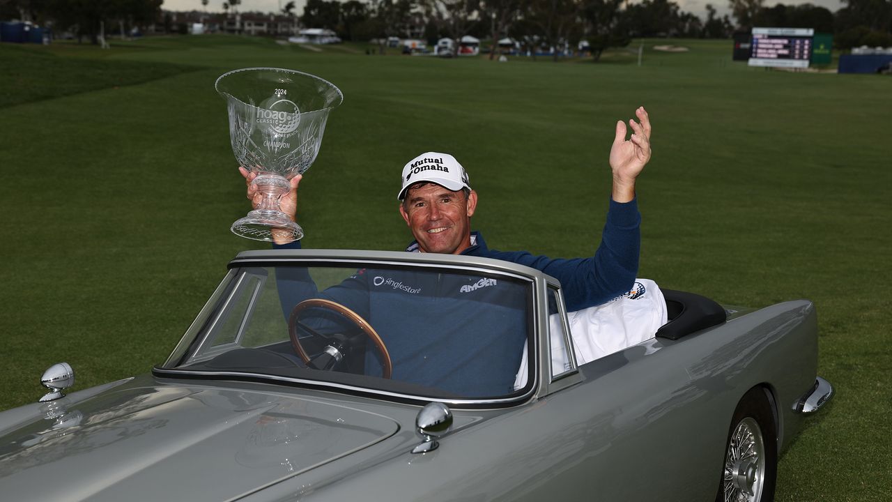 Padraig Harrington poses for a photo with the winner&#039;s trophy in a miniature Aston Martin after the 2024 Hoag Classic Newport Beach