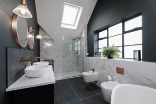 a bathroom with a roof light over the shower