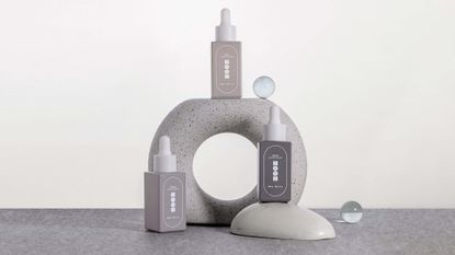 Noon nootropic in three grey square bottles against white background 