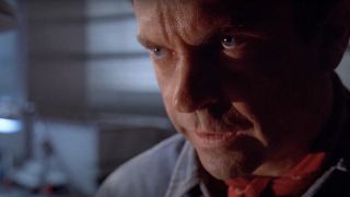 Sam Neill looking up in fear in Jurassic Park.