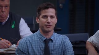 Andy Samberg speaking at a desk in Brooklyn Nine-Nine.