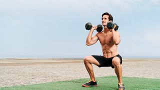 Man performing weighted squats outside