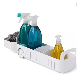 White roll out sink caddy with cleaning products on it