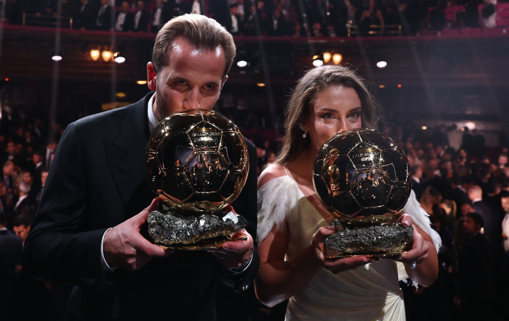Spain and Barcelona midfielder Alexia Putellas and England and Bayern Munich forward Harry Kane kiss their trophies on stage after receiving their Ballon d'Or awards for the best female and male footballer