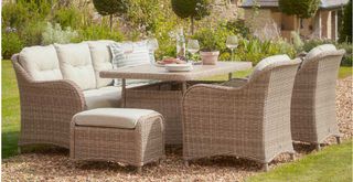 garden with a wicker dining set with a sofa and armchairs