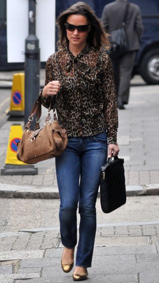 Pippa Middleton, wearing jeans and a leopard print shirt, walks in London in September 2011