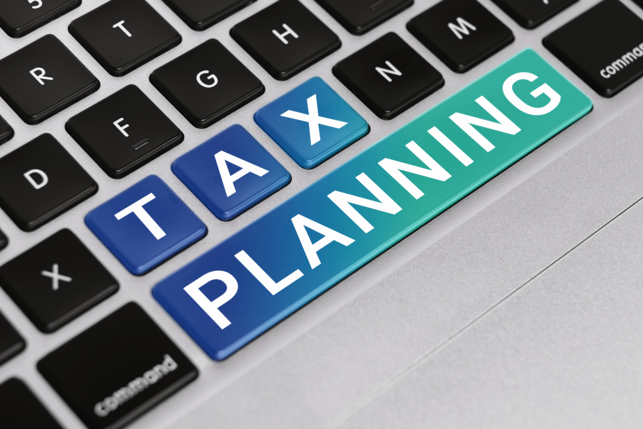the words &#039;tax planning&#039; written out on the keys of a keyboard