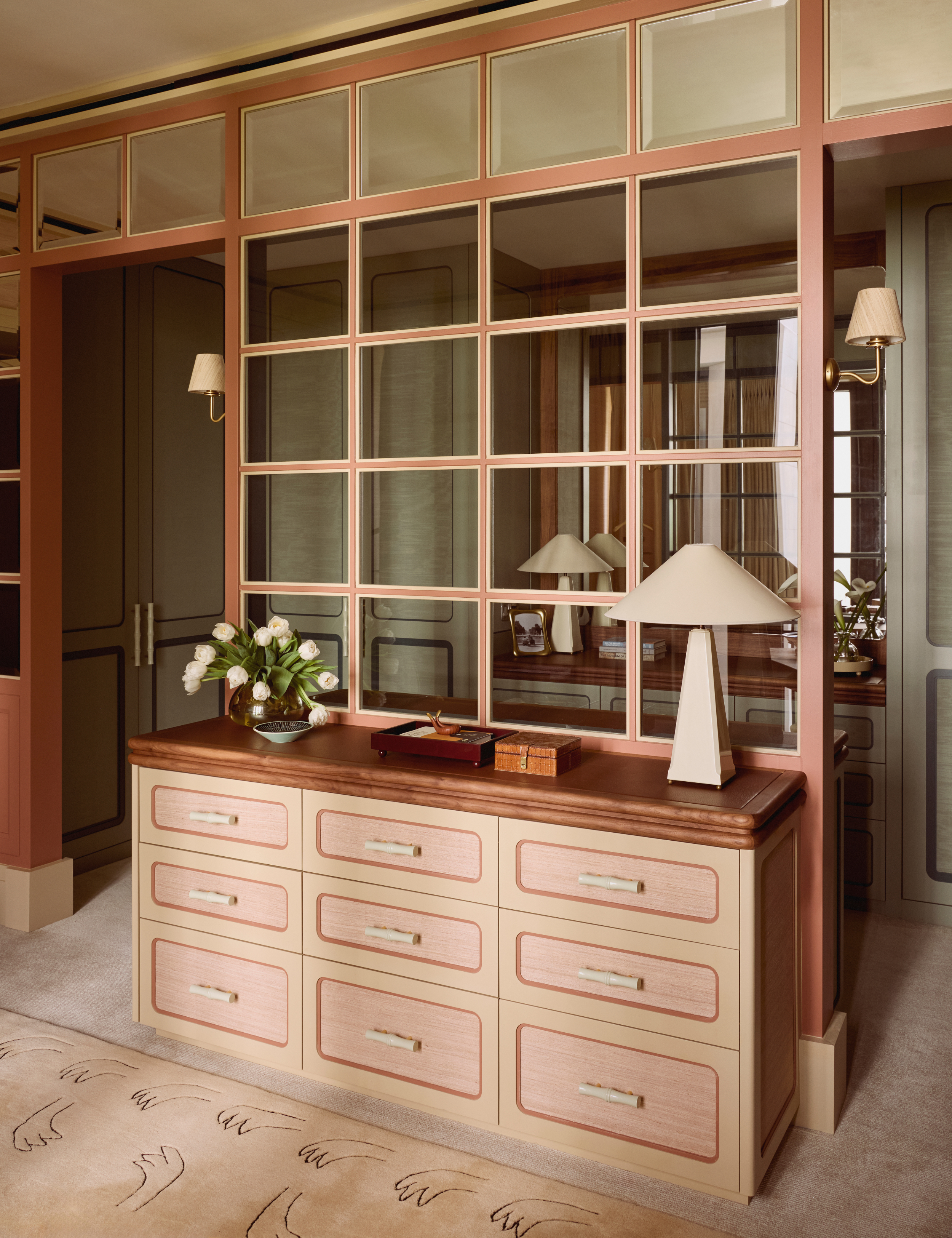 Light terracotta-and-brown wood-top dresser accented by a grided windowpane divider and collected objects