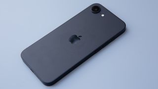 iPhone 16e in black on blue background