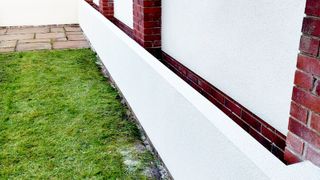 New rendered garden wall panted white
