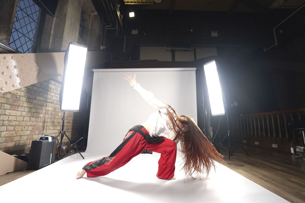Sony A7 V sample images &ndash; dancer's movement frozen, with background roll and lights included in the frame