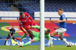 Virgil Van Dijk goes down under the challenge from Everton goalkeeper Jordan Pickford