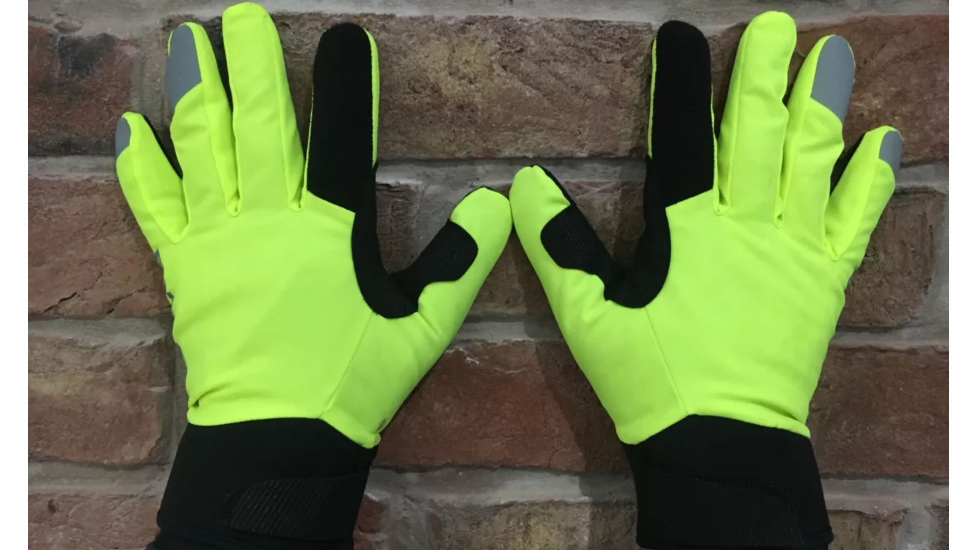 Endura Strike gloves are shown on hands held up against a brick wall and are a great winter cycling glove for affordability