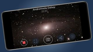A smartphone showing an image of the Andromeda galaxy