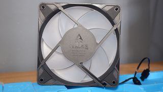 An Arctic Liquid Freezer III Pro liquid cooler set-up on a test bench with the RGB enabled.