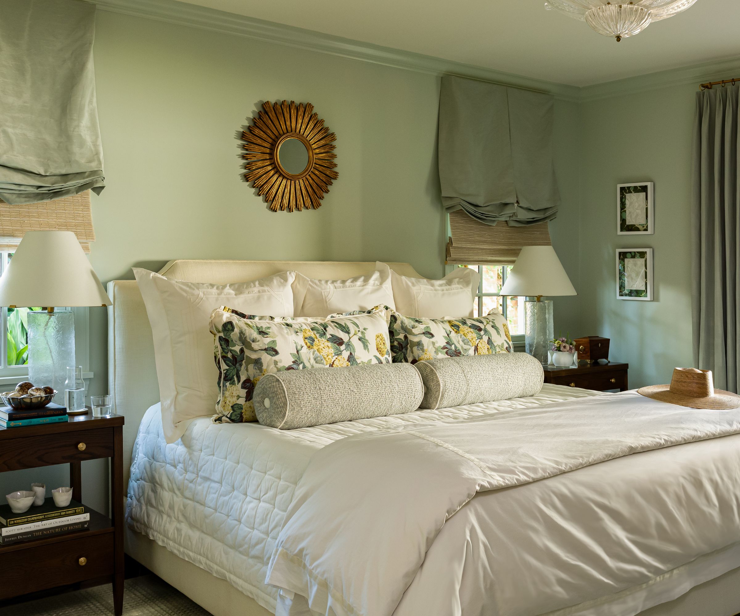 A traditional bedroom with pale green walls.