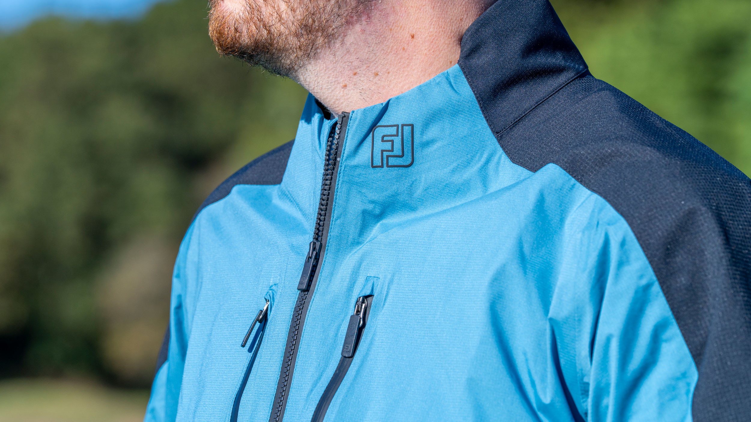 A close-up of the neck section on the FJ Arcus rain jacket on a male