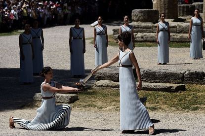 Actresses light the ceremonial flame that will be carried to the Olympics