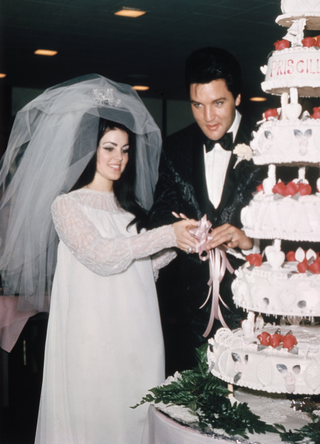 Elvis Presley cuts wedding cake with his bride, the former Priscilla Ann Beaulieu, May 1, 1967 in Las Vegas