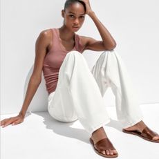 Zara model wearing brown Soft Leather Slides with pink tank top and white pants