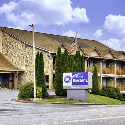 The outside of a Best Western hotel with an American flag outside