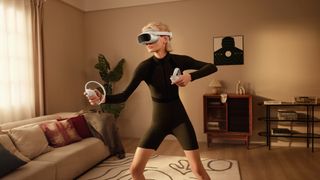 Photo of a woman working out in a living room while wearing the Pico 4 VR headset.