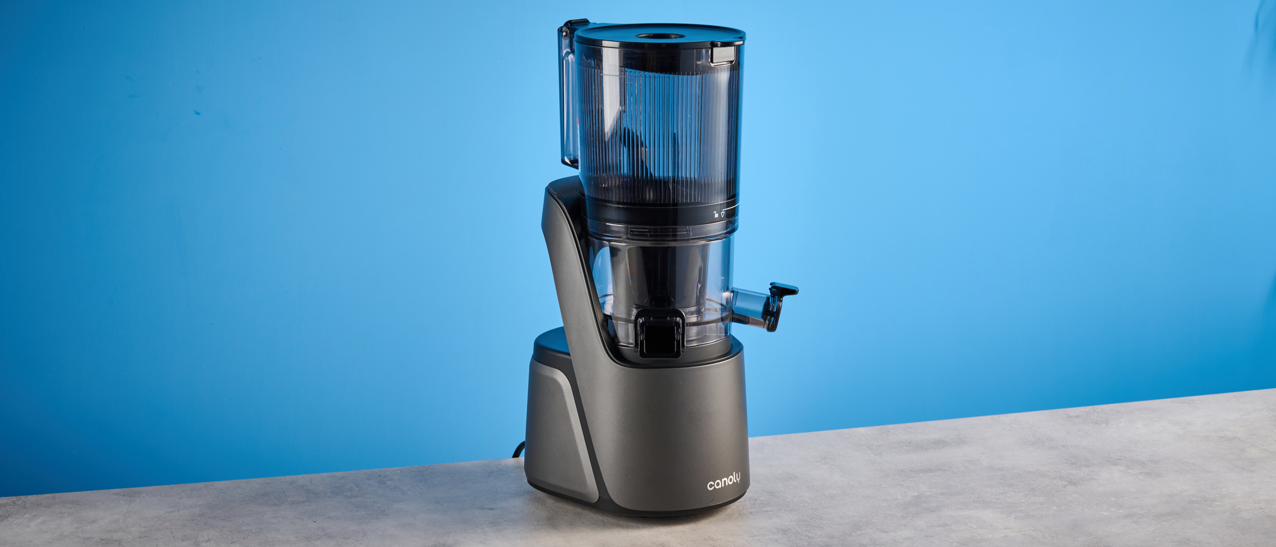 Canoly C16 Cold Press Juicer photographed in front of a blue background