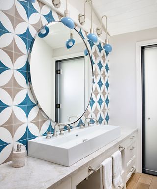 bathroom with geometric tiles and basins