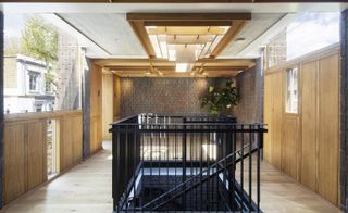 interior showing central metal staircase at Southwark brick house by Satish Jassal