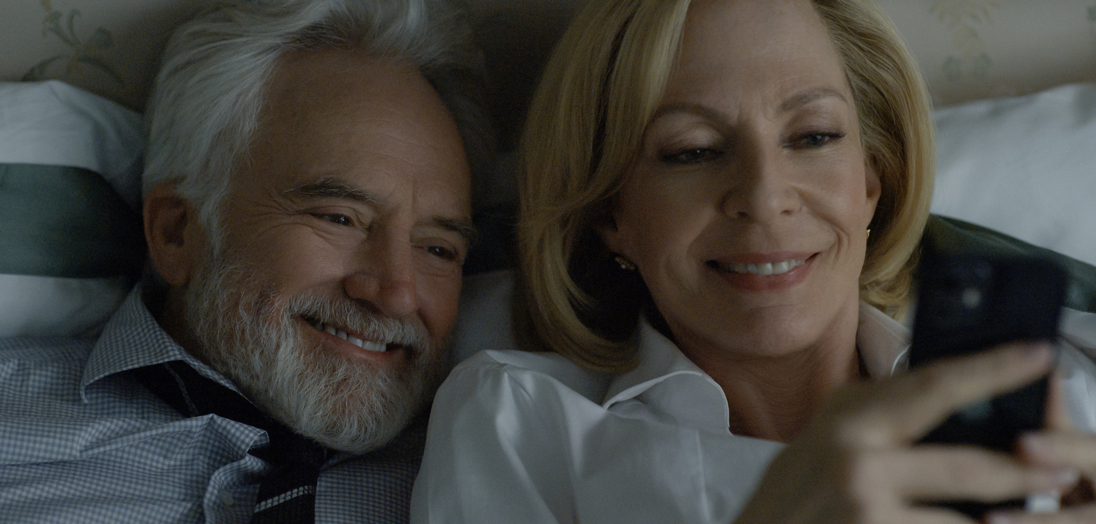 bradley whitford and allison janey in bed looking at her phone in the diplomat season 3