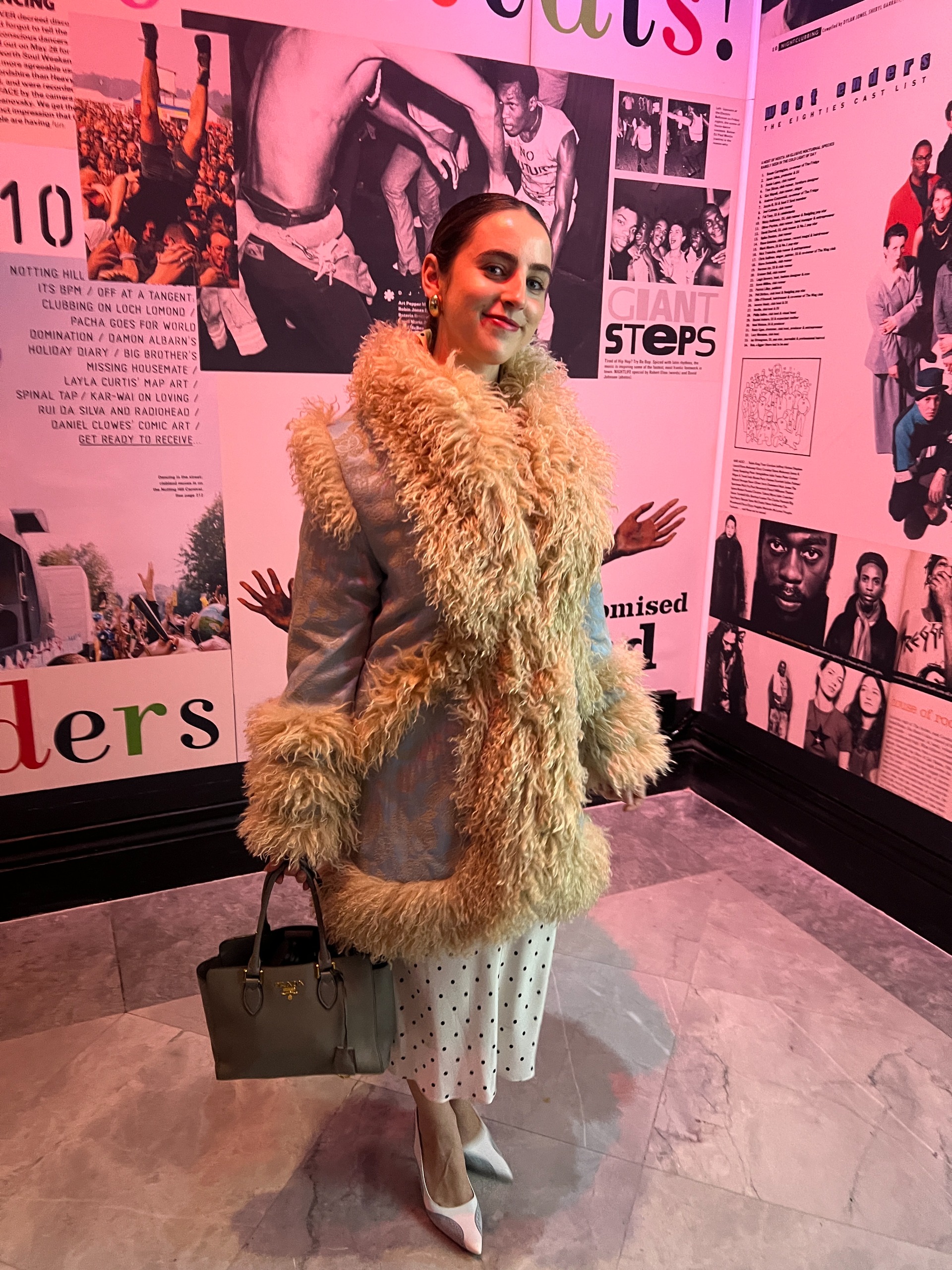 An image of Who What Wear writer Ava Gilchrist wearing a Penny Lane coat with a polka-dot dress.