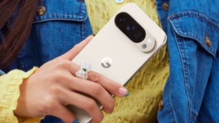 google pixel 10 pro in porcelain in front of a yellow shirt