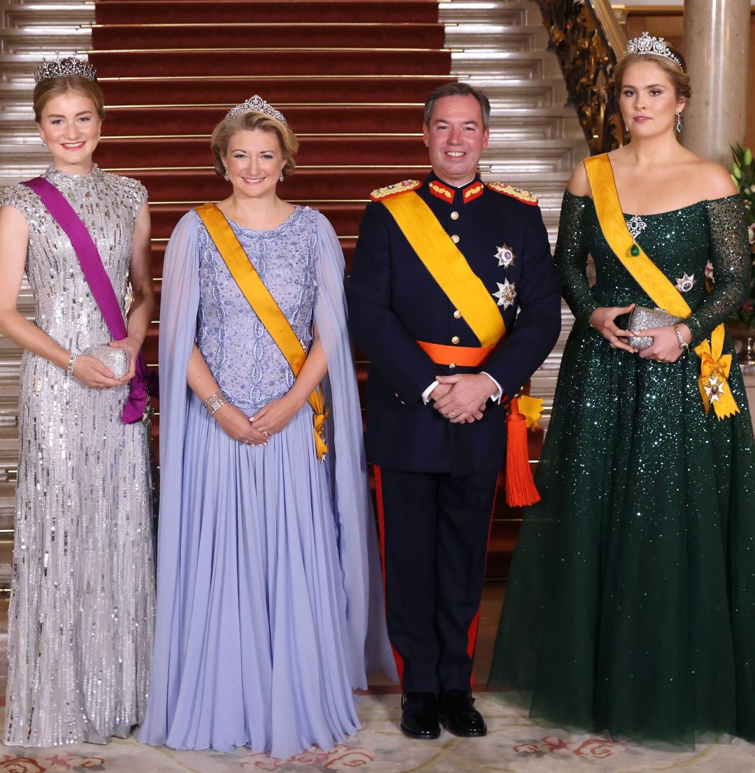 Princess Elisabeth, Grand Duchess Stephanie, Grand Duke Guillaume, Princess Catharina-Amalia wearing evening gowns and military uniform in front of a staircase