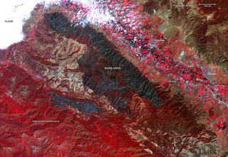 This false-color map, created using data from NASA's Terra satellite, shows the burn area of the River and Carmel fires in Monterey County, California, on Aug. 26, 2020. Vegetation is shown in red, and the burn area (dark blue/gray) is in the center of the image.