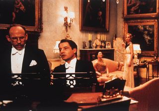 Jeremy Northam plays piano while Bob Balaban and Kristin Scott Thomas listen