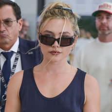 Florence Pugh arrives at the Venice airport in a blue dress and high-heeled sandals. 