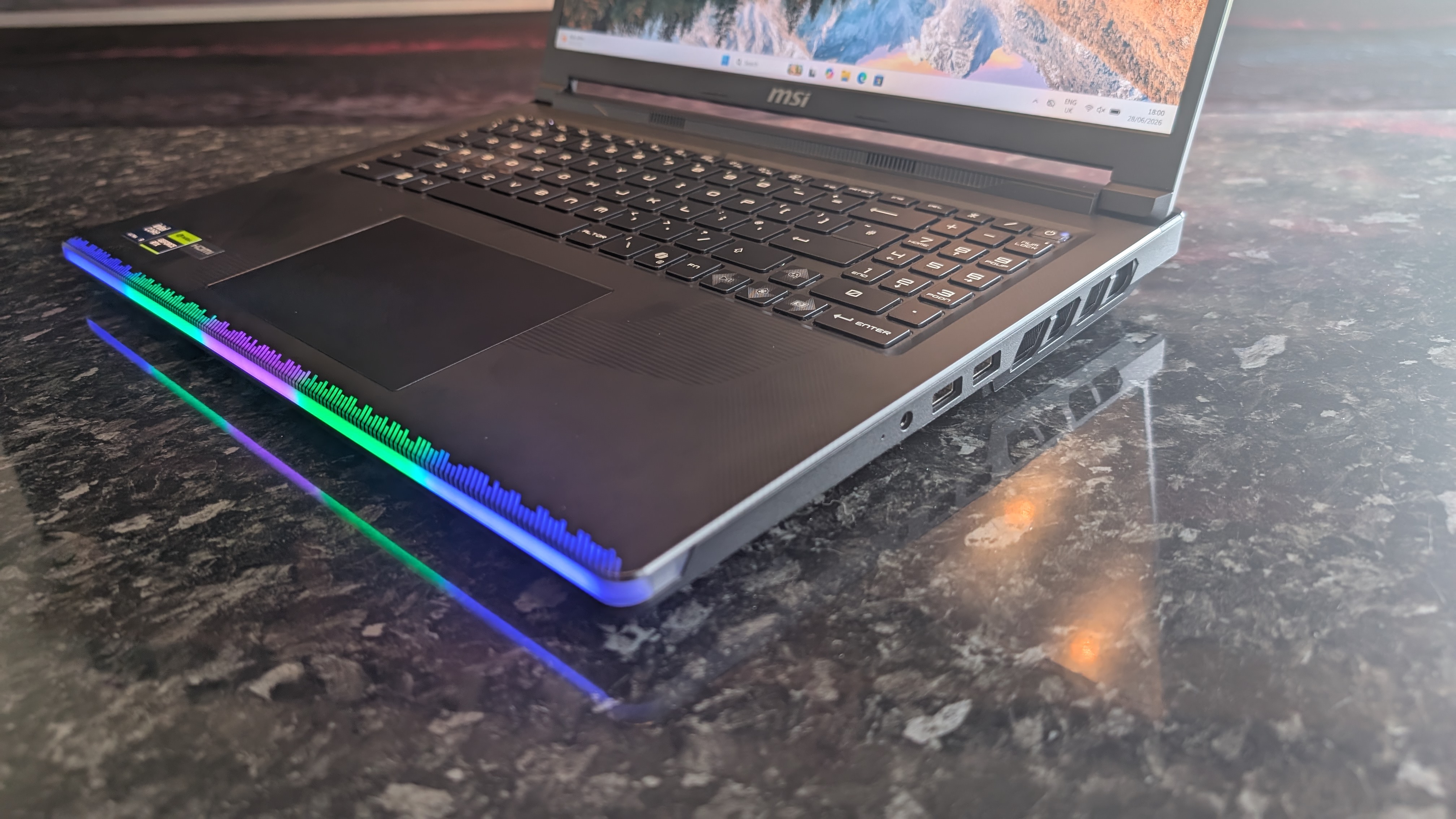 The MSI Raider 16 Max HX gaming laptop pictured on a black marble worktop.
