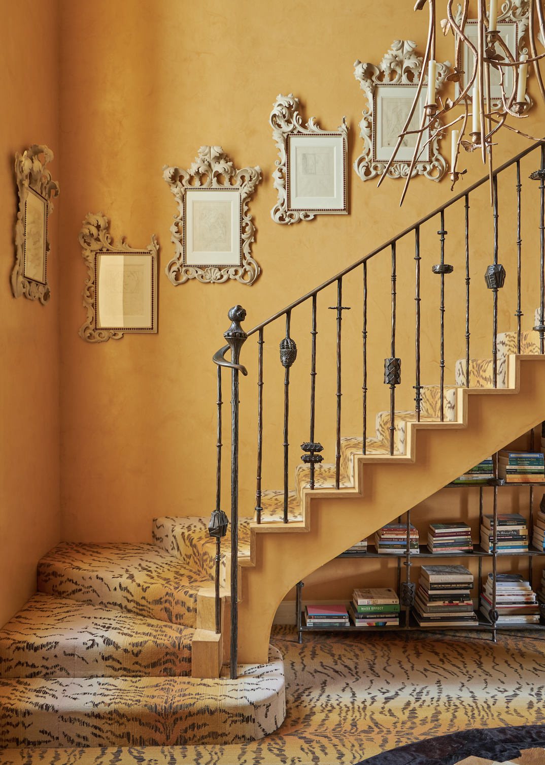 The staircase in Pauline’s London home has bannisters and a bookcase designed by Bonetti, and a Lanterne by Claude Lalanne. Hung on the walls are a series of etchings by Pablo Picasso Picasso from 'Les Métamorphoses d'Ovide'. It is painted bright yellow and the floors are covered in animal print carpet